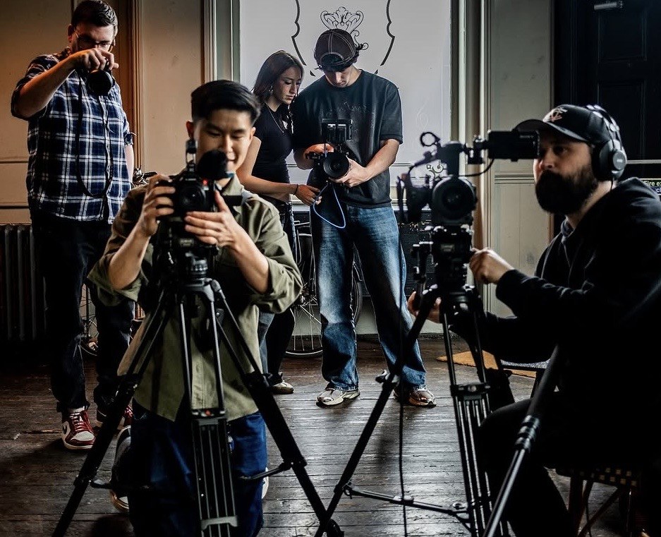 A film crew shooting a music video with an artist on set